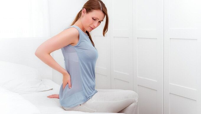 A woman is worried about back pain.